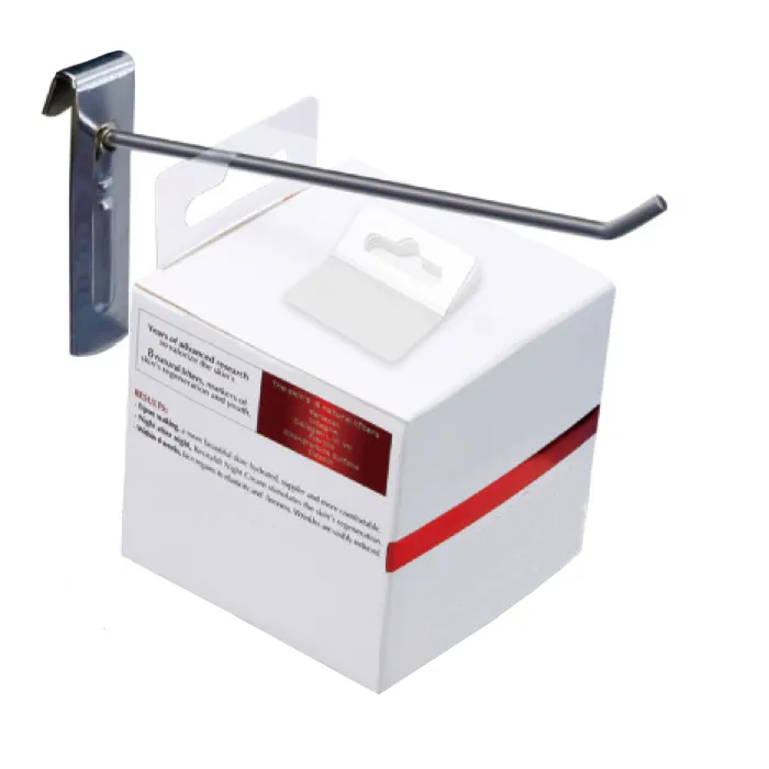flexible-hang-tabs-3 White product box hanging on a peg hook using flexible self-adhesive hang tabs, with a 5-piece stack placed on top.
