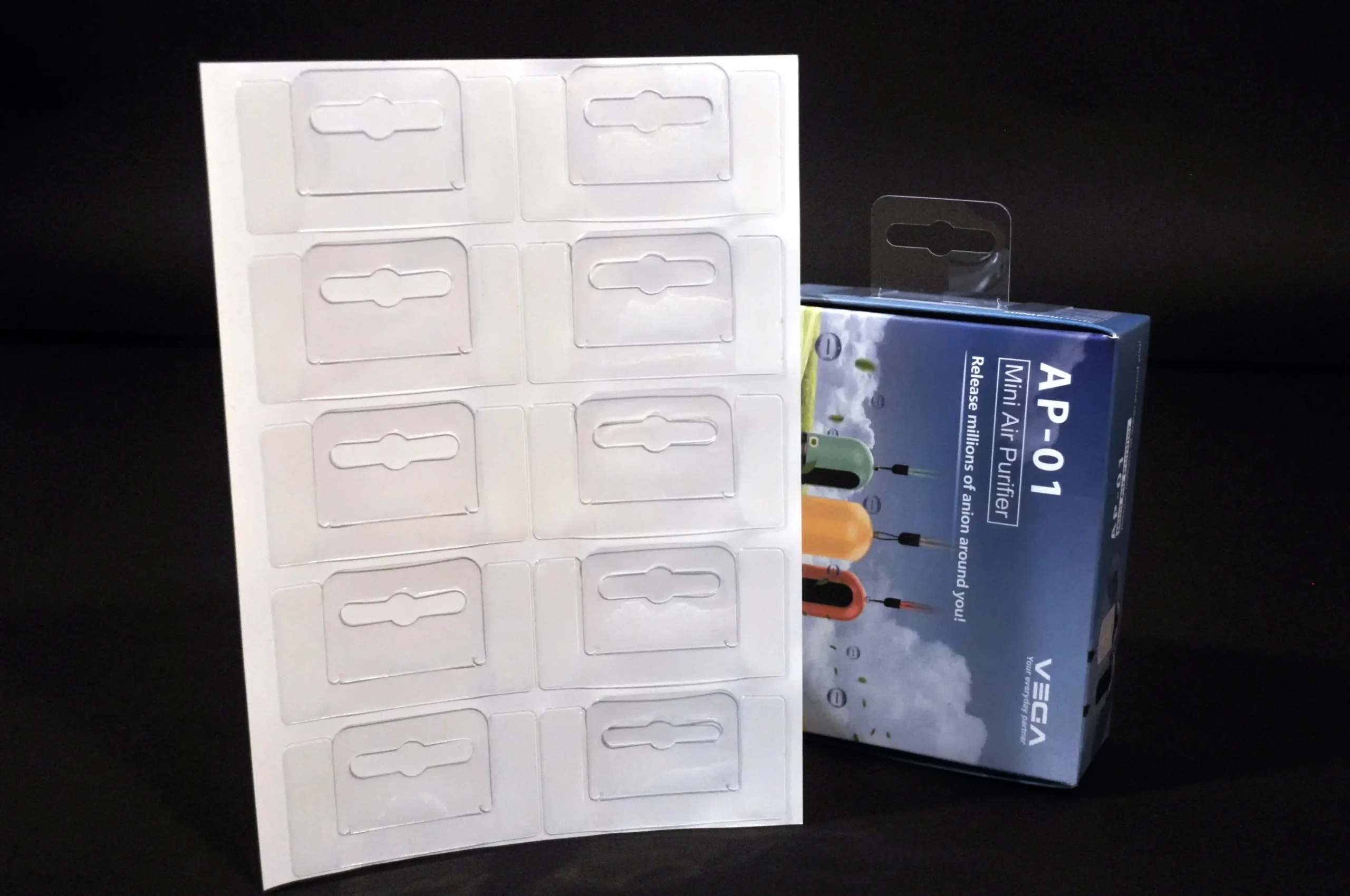 Self-Adhesive Foldable Hang Tabs 4 Clear PET adhesive hang tabs on sheet with Euro hole, shown with retail packaging for hanging display application.
