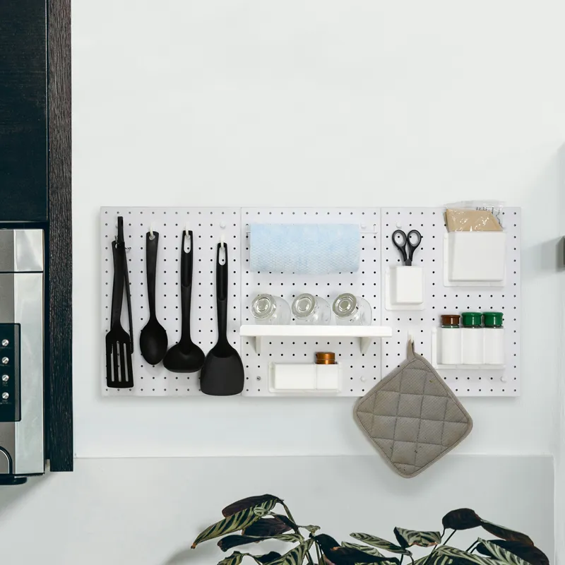 12″x16″ Pegboard Organizer Kit (3-Piece Set) 7 White MDF pegboard organizer kit mounted on a kitchen wall, featuring hooks for utensils, a paper towel holder, and shelves for spice jars.